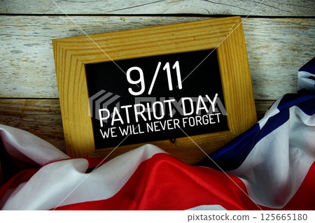 911 Patriot Day Never forget text message with USA flag on wooden background 125665180