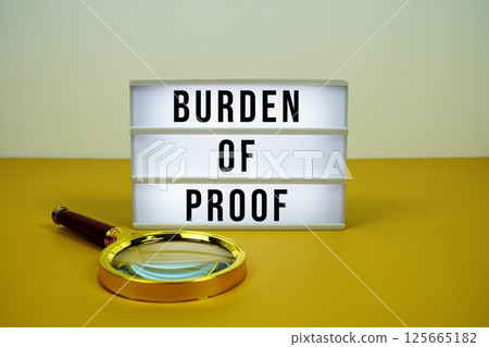 Burden Of Proof text on light box with magnifying glass on yellow background Burden Of Proof text on light box with magnifying glass on yellow background 125665182