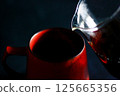 Coffee poured into a red cup 125665356