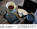 Preparing drip coffee, table with coffee beans and dripper 125665357