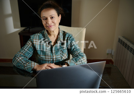 Confident Woman Working Remotely in a Home Office Environment 125665610