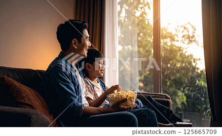 Father and child having fun with bowl of popcorn. Generated image Father and child having fun with bowl of popcorn. Generated image 125665709