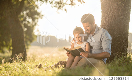 Dad and daughter reading a book together under a tree. Generated image 125665814