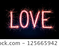 A sparkling representation of the word "Love" illuminated against a dark background through vibrant sparkler effects, symbolizing passion and affection, Valentines Day celebrations. 125665942