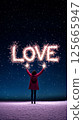 Brightly lit sparklers spell the word "Love" against a starry night sky. Concept of joy, celebration, and togetherness, symbolizing Valentine's Day and romantic moments. 125665947