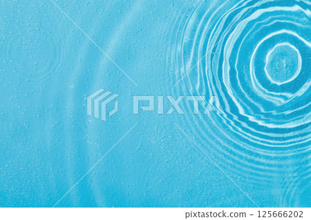 drops on water with circles on a blue background drops on water with circles on a blue background 125666202