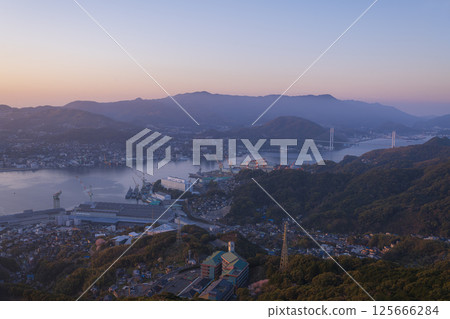 Nagasaki at dawn as seen from Mount Inasa, and the city bathed in the morning sun 125666284