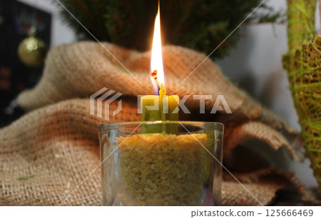 Folk tradition to light a candle near the home tree and baskets of gifts symbolizing home grace  125666469