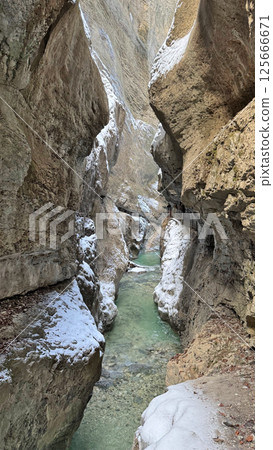 Majestic narrow Bayern Partnach Gorge with flowing water, snow-covered rocks natural beauty concept Majestic narrow Bayern Partnach Gorge with flowing water, snow-covered rocks natural beauty concept 125666671