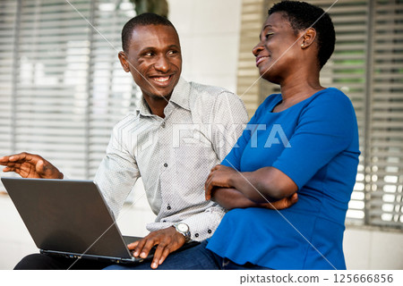 portrait of young people with laptop smiling. 125666856