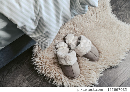 Female soft slippers on faux fur rug Female soft slippers on faux fur rug 125667085