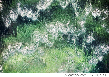 Background material photo of a close-up of an artificial waterfall glowing green 125667141