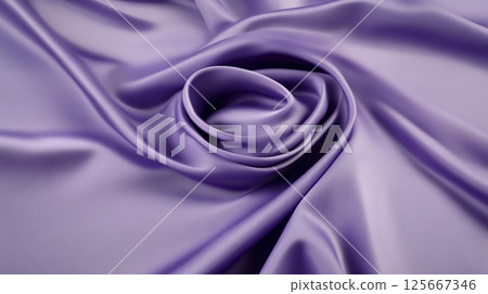 Flowing purple silk fabric in spiral pattern with smooth texture 125667346