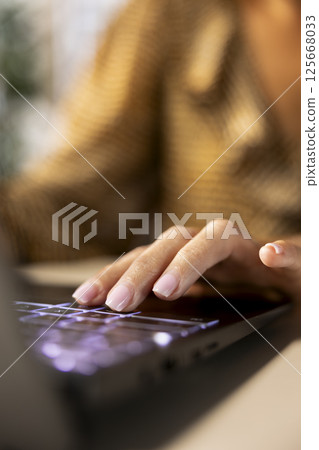 Professional manager at a multinational company works on laptop to track project progress and deadline completion. Office worker ensuring smooth task management and decision making. Close up. 125668033