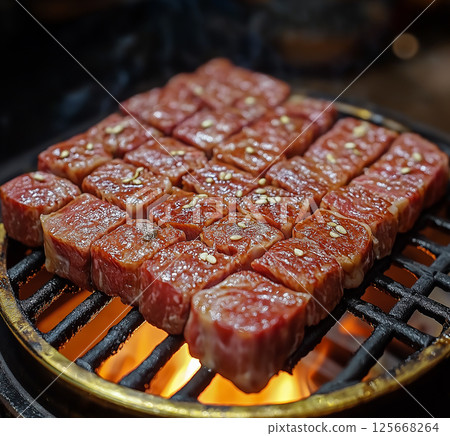 Delicious beef grilling on barbecue for gourmet yakiniku dinner with sizzling meat 125668264