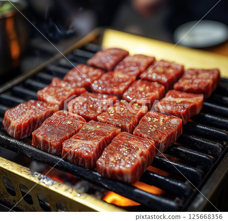 BBQ grill with sizzling steak and delicious meat on fire for gourmet outdoor dining experience. 125668356