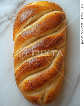 Braided bread with poppy seeds, fresh and wholesome baking perfect for an artisan food experience Braided bread with poppy seeds, fresh and wholesome baking perfect for an artisan food experience 125668372