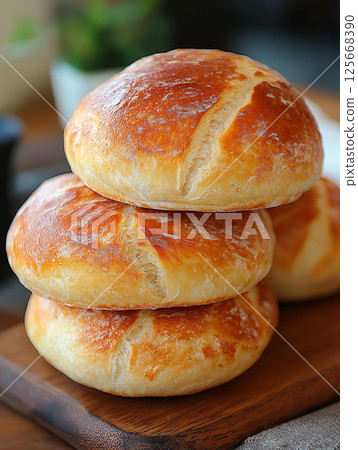 Freshly baked bread stacked in a bakery showcasing homemade crust and artisan meal options Freshly baked bread stacked in a bakery showcasing homemade crust and artisan meal options 125668390
