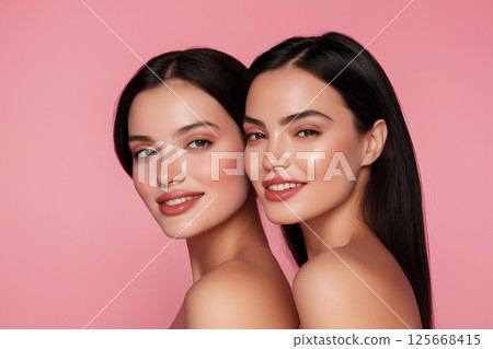 Beautiful portrait of twins showcasing beauty, skin, and glamour with a radiant smile and makeup 125668415