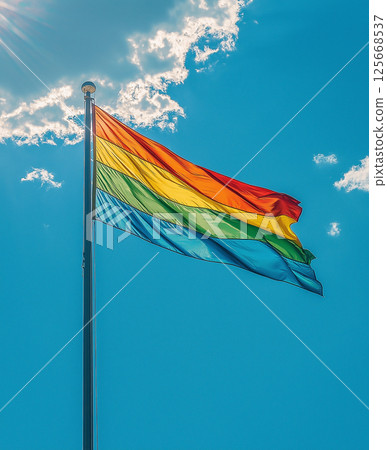 A pride flag waving in the sky symbolizing freedom, unity, and colorful celebration of identity A pride flag waving in the sky symbolizing freedom, unity, and colorful celebration of identity 125668537