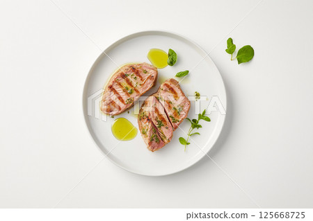 Gourmet grilled food on a plate with herbs and oil, a delicious dinner presentation Gourmet grilled food on a plate with herbs and oil, a delicious dinner presentation 125668725
