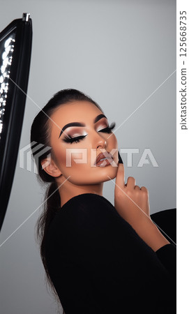 Glamour portrait featuring makeup beauty, cosmetics, and fashion style in an elegant studio Glamour portrait featuring makeup beauty, cosmetics, and fashion style in an elegant studio 125668735