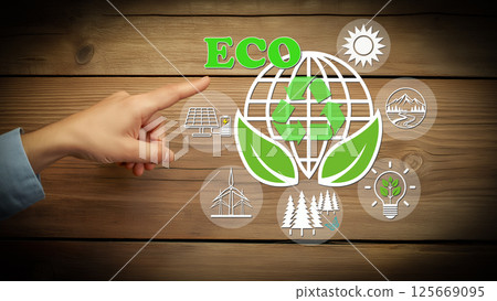ECO and recycling symbols and sustainable energy icons floating on a wood grain background 125669095