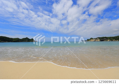 beautiful sandy beach and blue sea beautiful sandy beach and blue sea 125669611