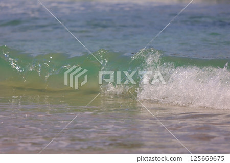 beautiful sandy beach and blue sea beautiful sandy beach and blue sea 125669675