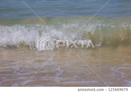 beautiful sandy beach and blue sea beautiful sandy beach and blue sea 125669679