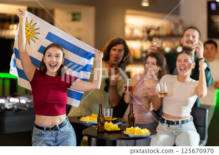 Group of fans in bar with Uruguayan flag 125670970