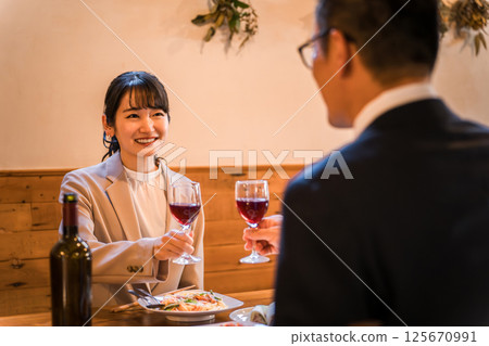 Couple in suits having dinner at a restaurant, colleagues 125670991
