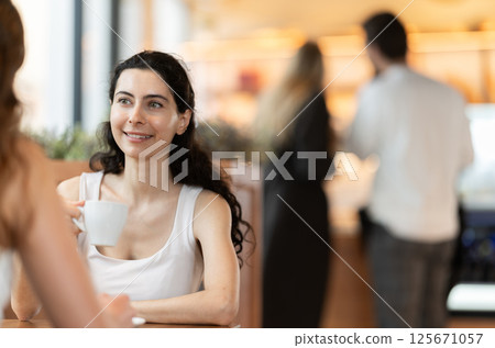 Woman at a meeting in a cafe with a friend Woman at a meeting in a cafe with a friend 125671057