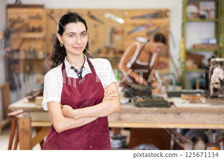 Girl is busy in carpentry workshop 125671134