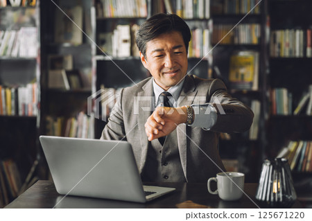 Middle-aged Asian male businessman (lawyer, executive, professor, law firm) in his study, office, or president's office 125671220