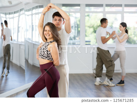 Couples of young men and women dancing waltz Couples of young men and women dancing waltz 125671285