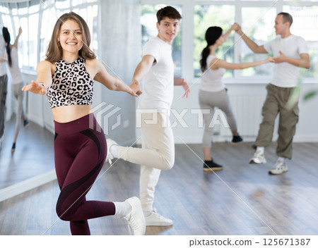 Girl paired up with young man, they train to perform disco fox dance, rehearse performance. Girl paired up with young man, they train to perform disco fox dance, rehearse performance. 125671387