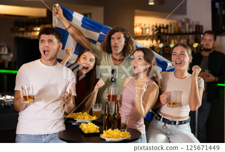 Group of friends cheer together for their favorite Greek team in beer bar 125671449