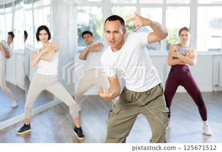 Young Asian man practicing modern street dance in studio Young Asian man practicing modern street dance in studio 125671512