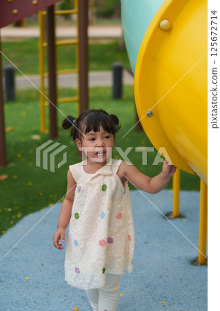 happy toddler girl playing at a outdoor playground in park happy toddler girl playing at a outdoor playground in park 125672714