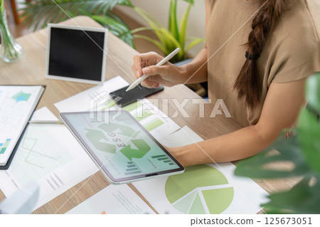 ESG sustainability analysis with graphs and charts on tablet 125673051