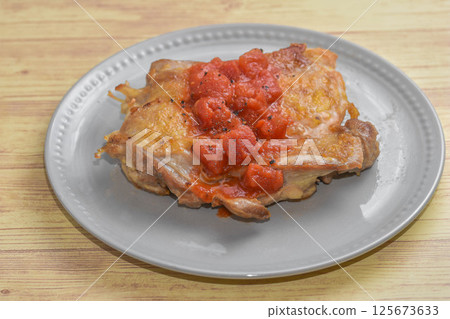Grilled chicken thighs with tomato sauce Grilled chicken thighs with tomato sauce 125673633