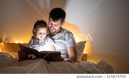 Dad and daughter reading a book together under a warm light. Generated image 125673705
