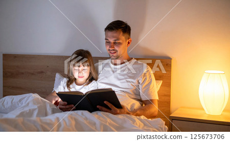 Dad and daughter reading a book together under a warm light. Generated image 125673706