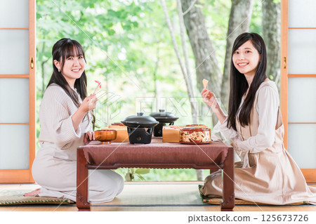 A woman enjoying kaiseki cuisine at a ryokan (room service, kaiseki cuisine, set meal, luxury) A woman enjoying kaiseki cuisine at a ryokan (room service, kaiseki cuisine, set meal, luxury) 125673726