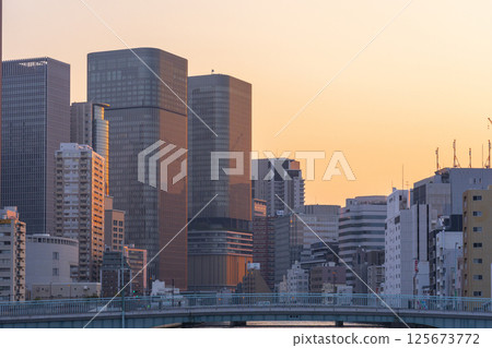 Nakanoshima buildings bathed in the morning glow (from Tosabori Bridge) Nakanoshima buildings bathed in the morning glow (from Tosabori Bridge) 125673772