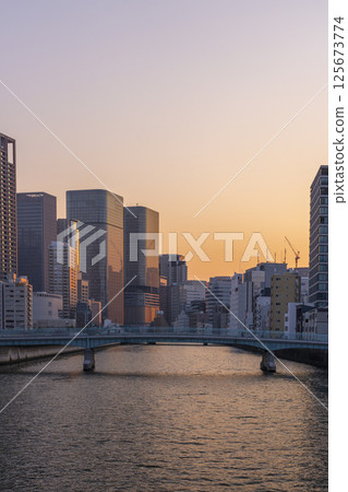 Nakanoshima buildings bathed in the morning glow (from Tosabori Bridge) Nakanoshima buildings bathed in the morning glow (from Tosabori Bridge) 125673774