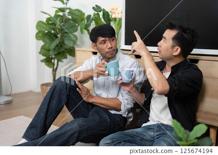 Conversation and Connection. Two men discussing over coffee in a cozy setting. Conversation and Connection. Two men discussing over coffee in a cozy setting. 125674194