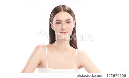 A beautiful young woman with clean, fresh skin against a white background. Skincare, facial treatment, cosmetology, beauty, and spa. An elegant portrait of an woman. 125674206