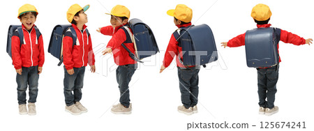 A boy in elementary school wearing a yellow safety hat and a backpack with a white background 125674241
